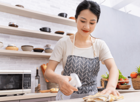 Woman wiping down benchtops